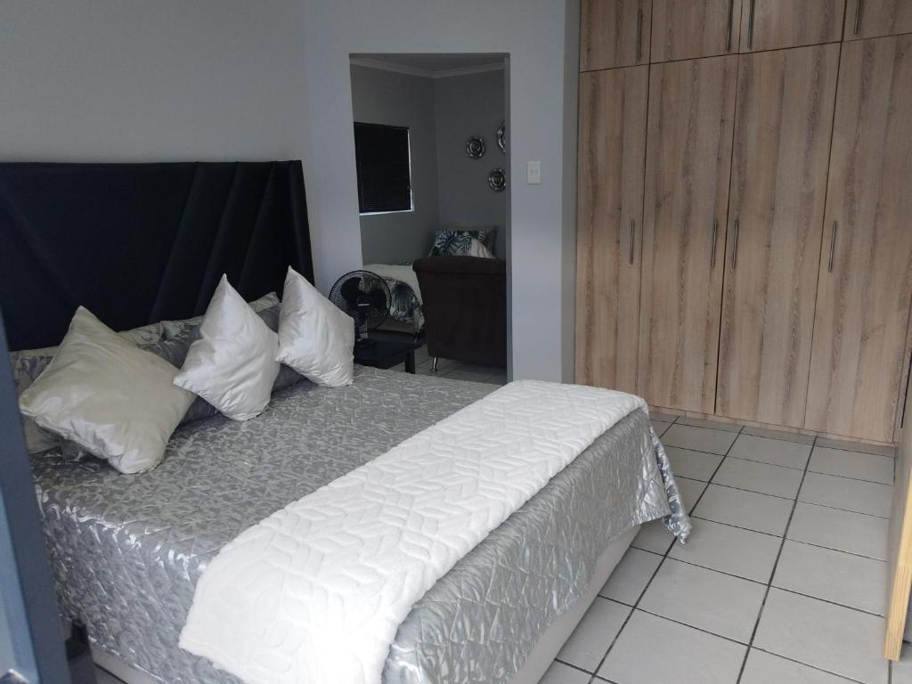 a bedroom with a bed with white sheets and pillows at The Gather Inn Bethlehem in Bethlehem