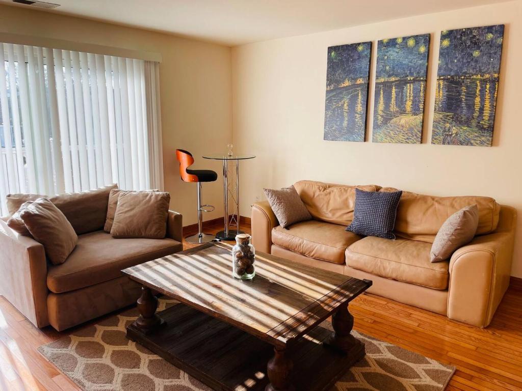 a living room with two couches and a coffee table at Spacious 2br2ba With Hardwood Floors in Cheltenham Village