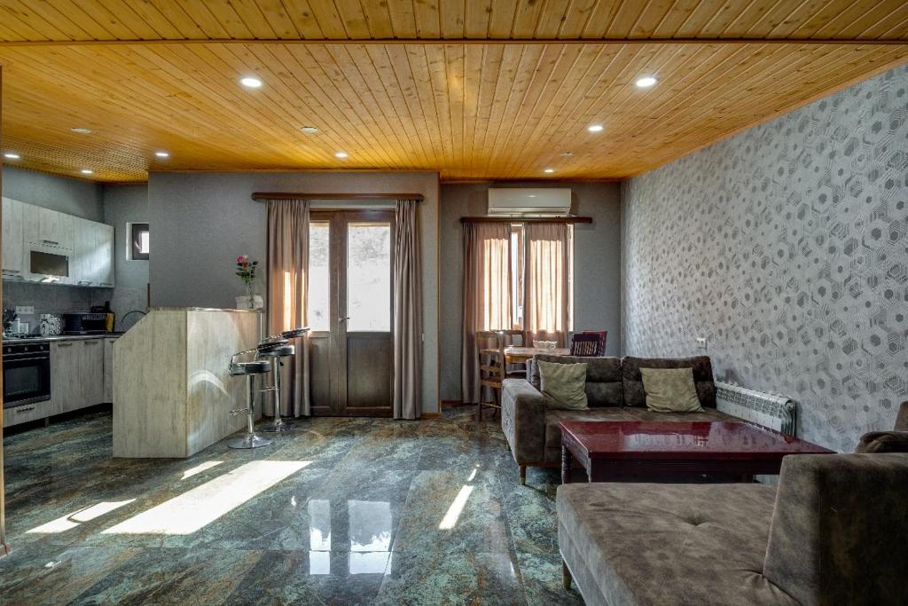 a living room with a couch and a table at Aleqs in Tbilisi City