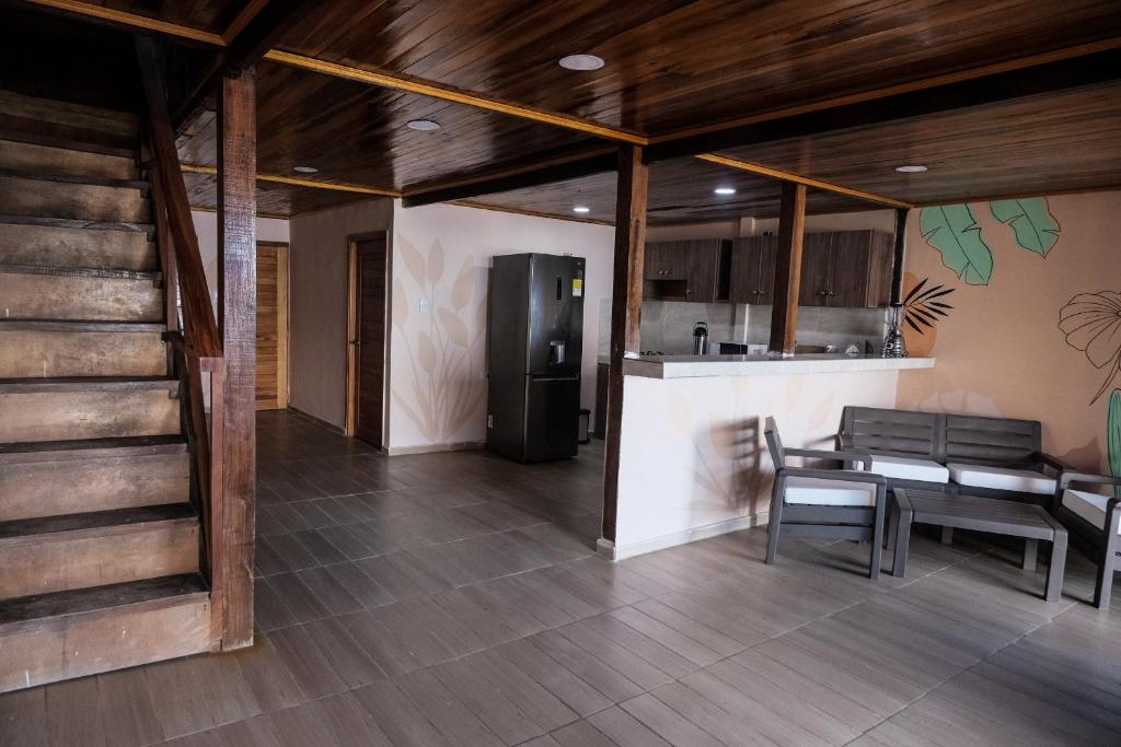 a kitchen with a refrigerator and a table and chairs at Cabaña Kokkos Del Mar in Santa Marta