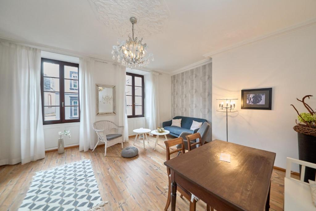 a living room with a table and a couch at Altstadt Residenz in Bernkastel-Kues