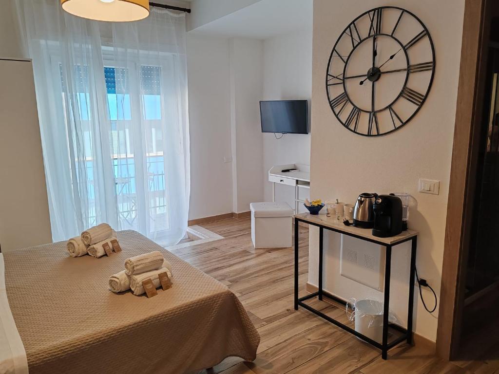 a bedroom with a large clock on the wall at DIMORE IN residenze asproni 24 in Cagliari