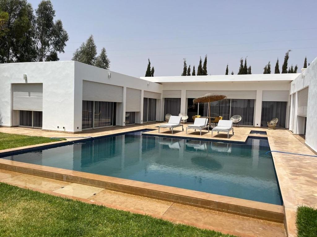 a swimming pool in the backyard of a house at Villa Zaara in Sehib Foukani
