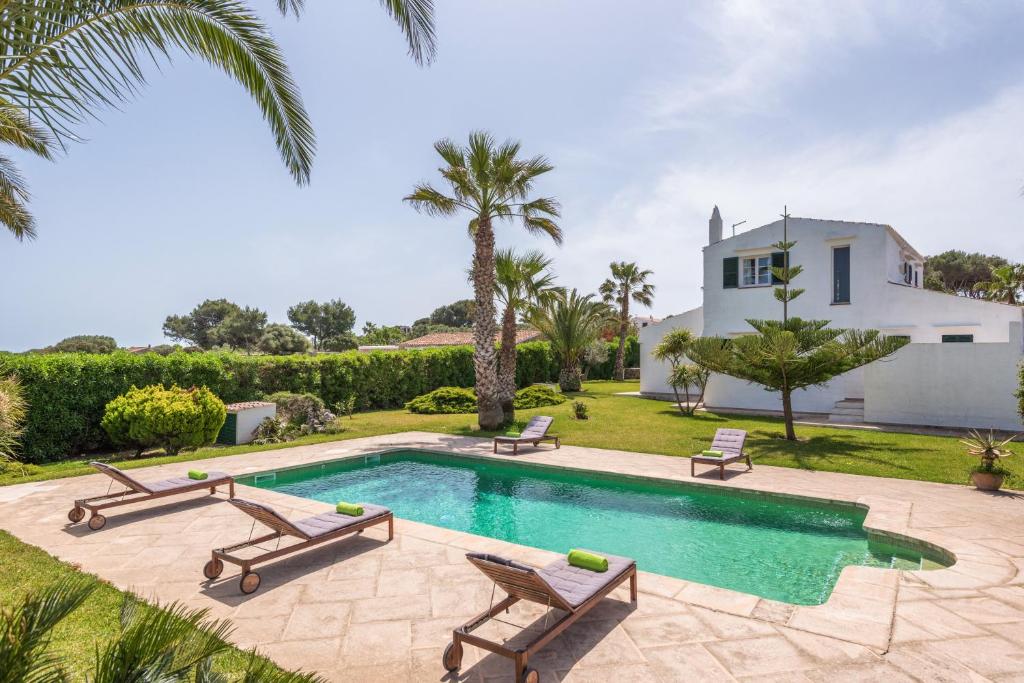 a villa with a swimming pool and a house at Los Olivos - Casa rural en exclusiva finca privada in Sant Lluis