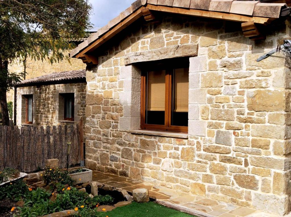 a stone house with a window on the side of it at Casa Rural Lorehonea in Artariáin