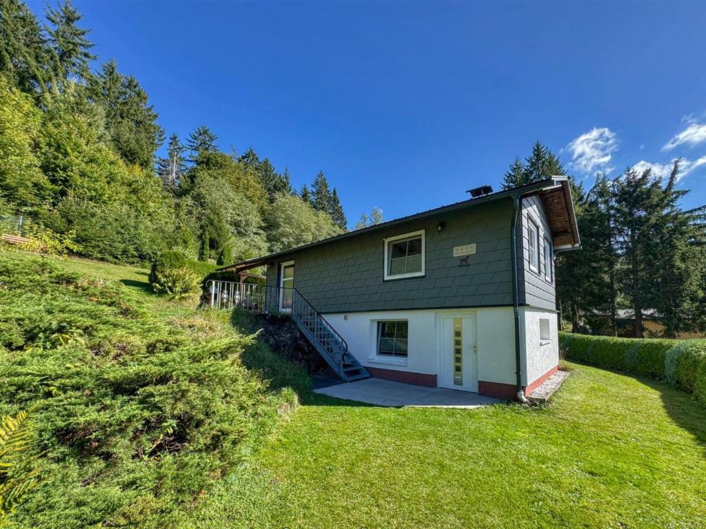 une petite maison sur une colline avec une cour dans l'établissement Am Arnsberg, à Unterschönau
