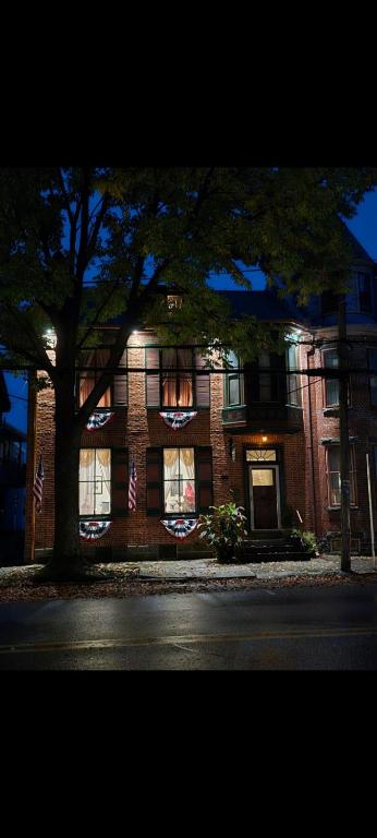 a brick building with a tree in front of it at Langdon Hill House in Gettysburg