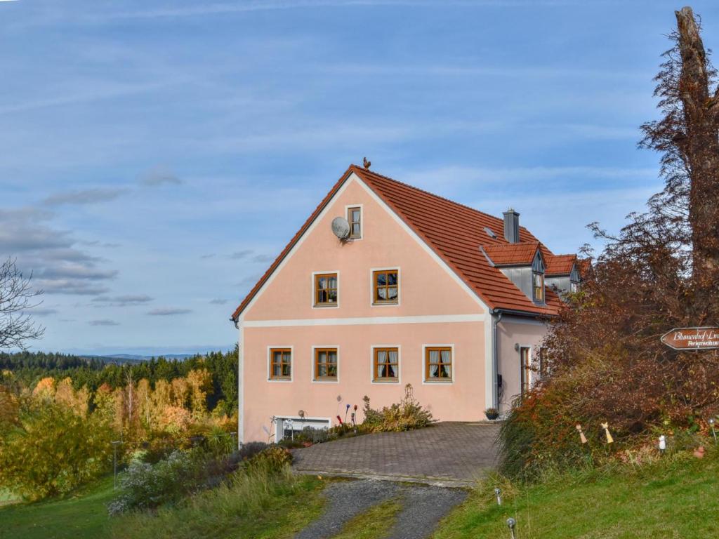a large white house with a red roof at Blumenhof II in Dietersdorf