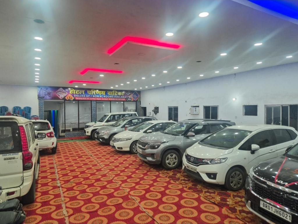 a row of cars parked in a parking lot at Hotel Parinay Vatika - Deoghar in Deoghar