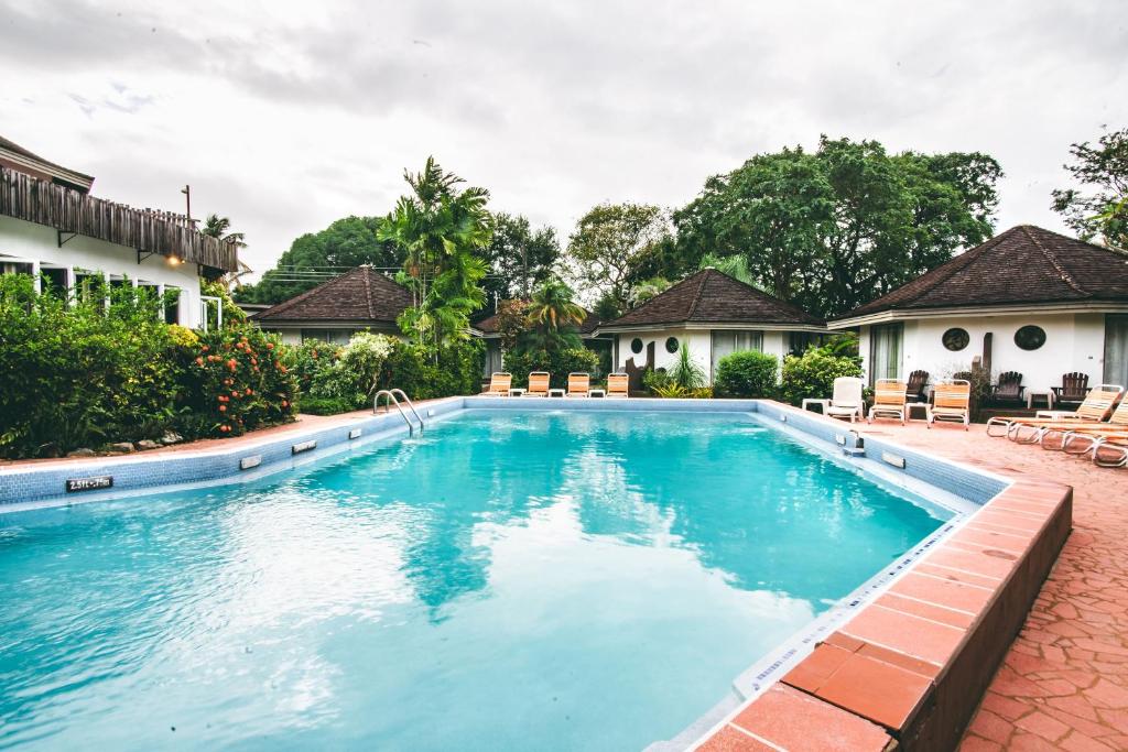 a swimming pool at a villa with a resort at Kariwak Wellness Village, Hotel and Holistic Haven in Crown Point