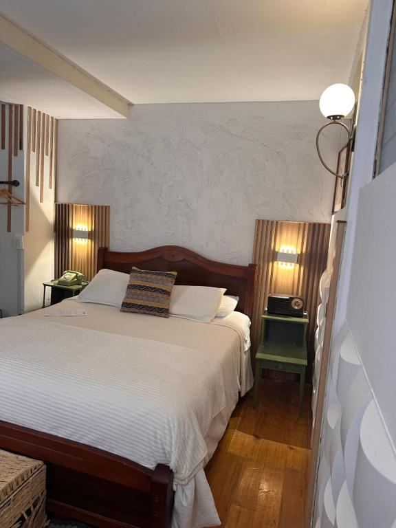 Ένα ή περισσότερα κρεβάτια σε δωμάτιο στο Skema Collections Quito