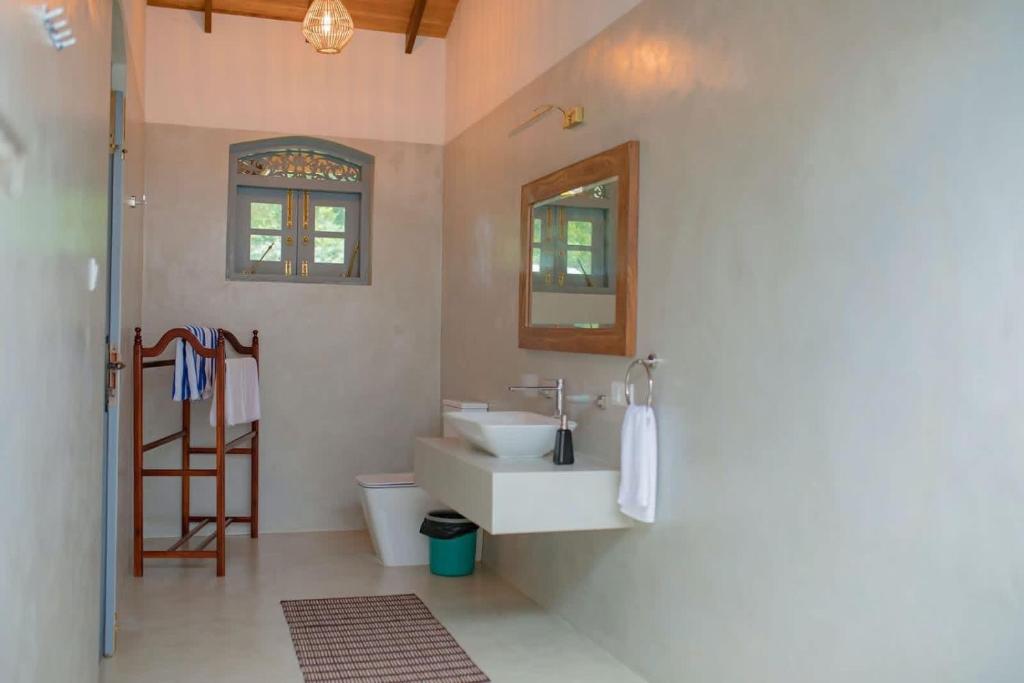 a bathroom with a sink and a mirror at KAIMANA HOUSE - 3 Min walk to the beaches in Tangalle