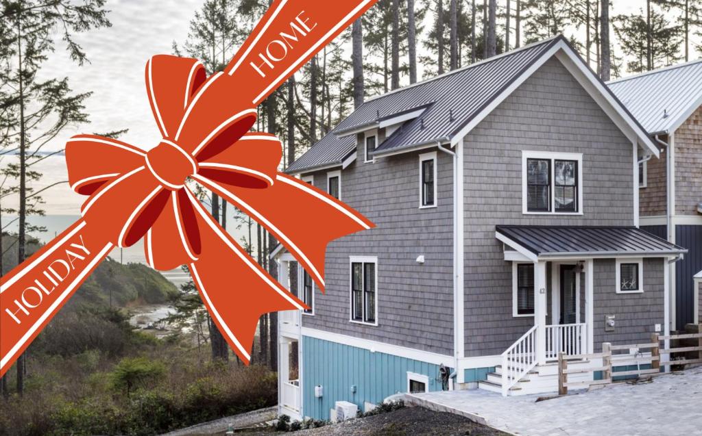 a house with a red bow in front of it at A Wave from It All by Seabrook Hospitality in Pacific Beach