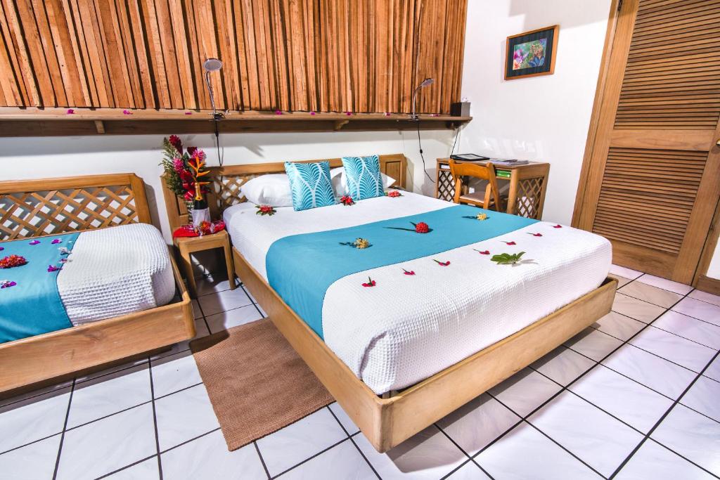 a bedroom with two beds in a room at Kariwak Wellness Village, Hotel and Holistic Haven in Crown Point