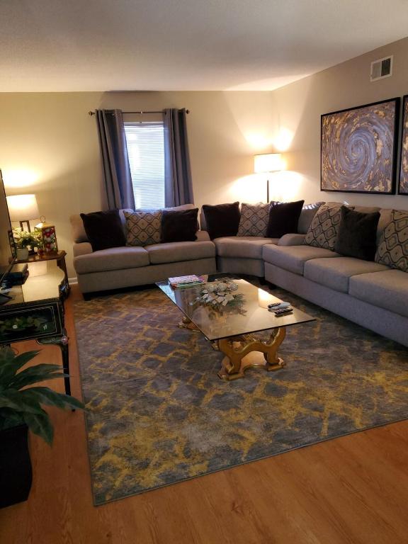 a living room with a couch and a coffee table at Abbies Place in Pine Bluff in Pine Bluff