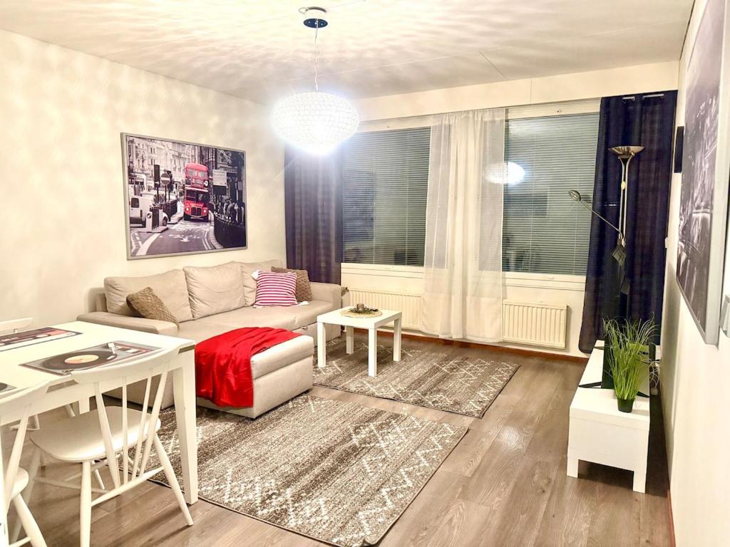 a living room with a couch and a table at Edullinen kaksio in Töysä