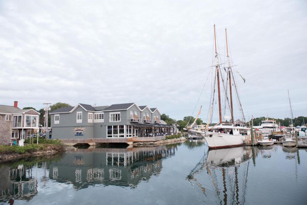 a boat is docked in a marina with houses at The Boathouse in Kennebunkport
