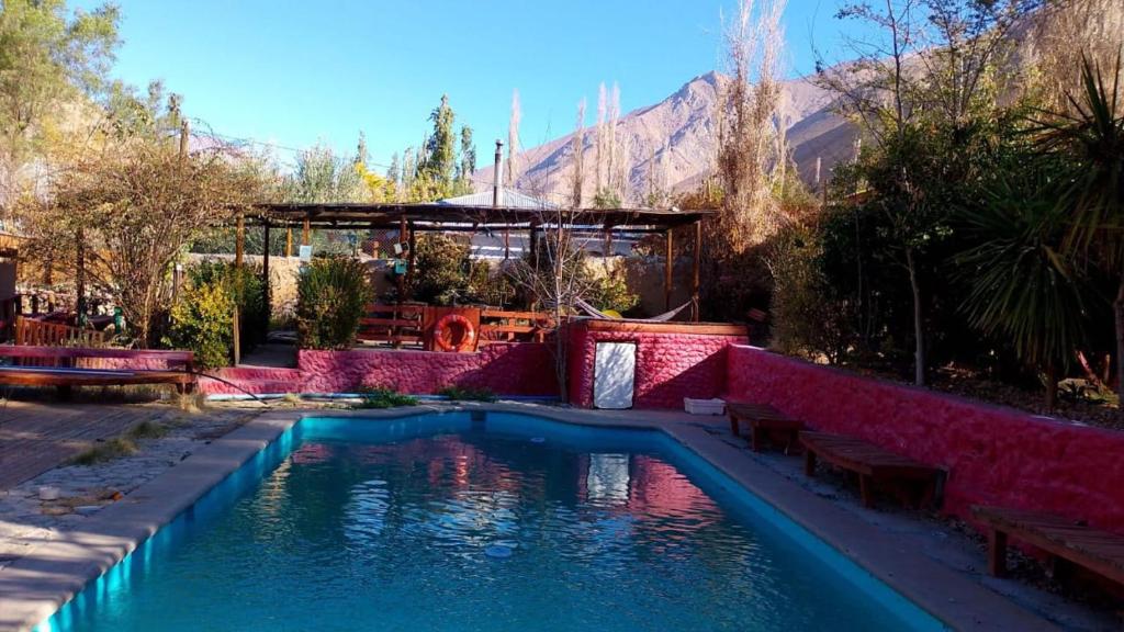 a swimming pool in a yard with a house at Lodge Gabriela Mistral in Pisco Elqui