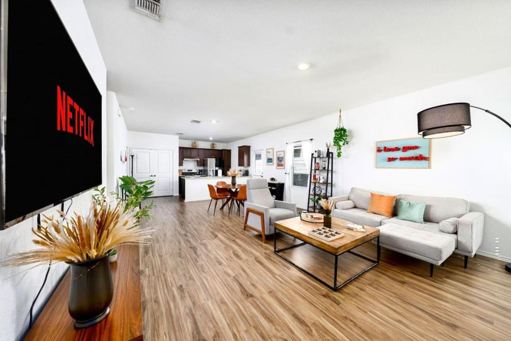 a living room with a couch and a tv at TONKA in Austin