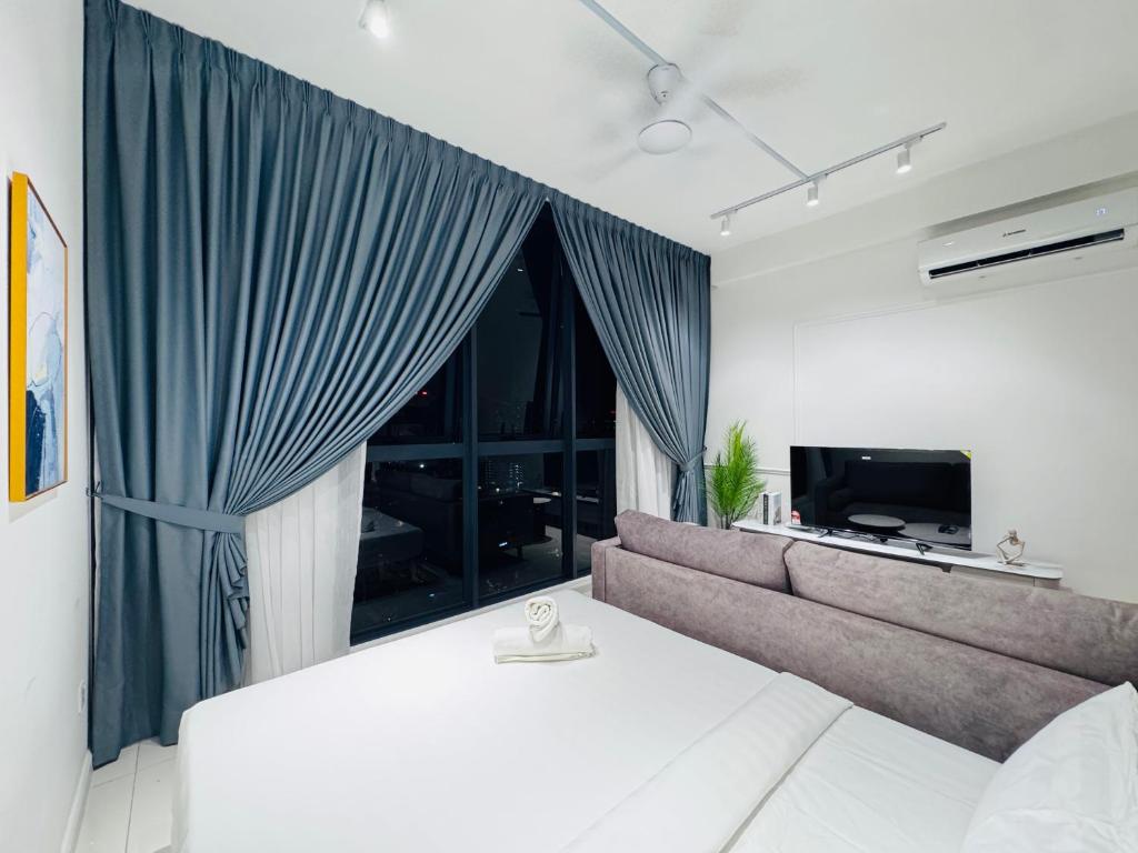 a living room with a couch and a large window at Majestic Residence KLCC By AFA in Kuala Lumpur