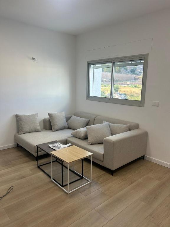 a living room with a couch and a table at Yarin's apartment in Qiryat Shemona
