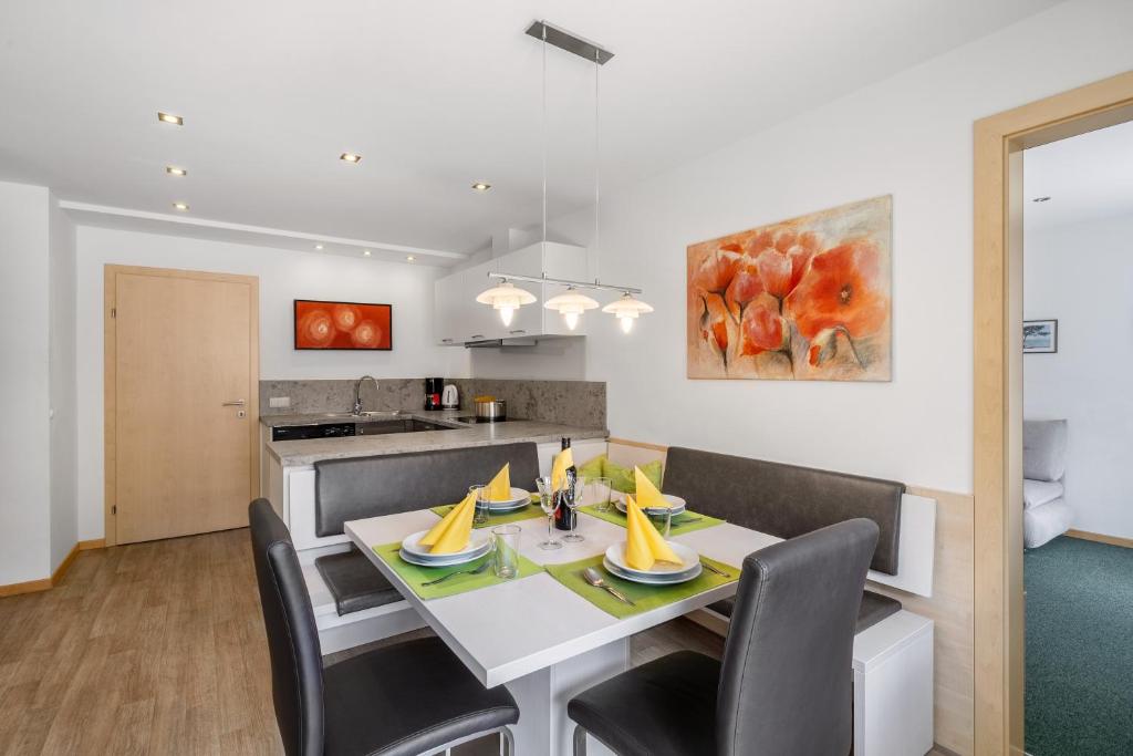 a kitchen and dining room with a table with bananas on it at Appartement Nr 2 Haus Voglreiter in Kaprun