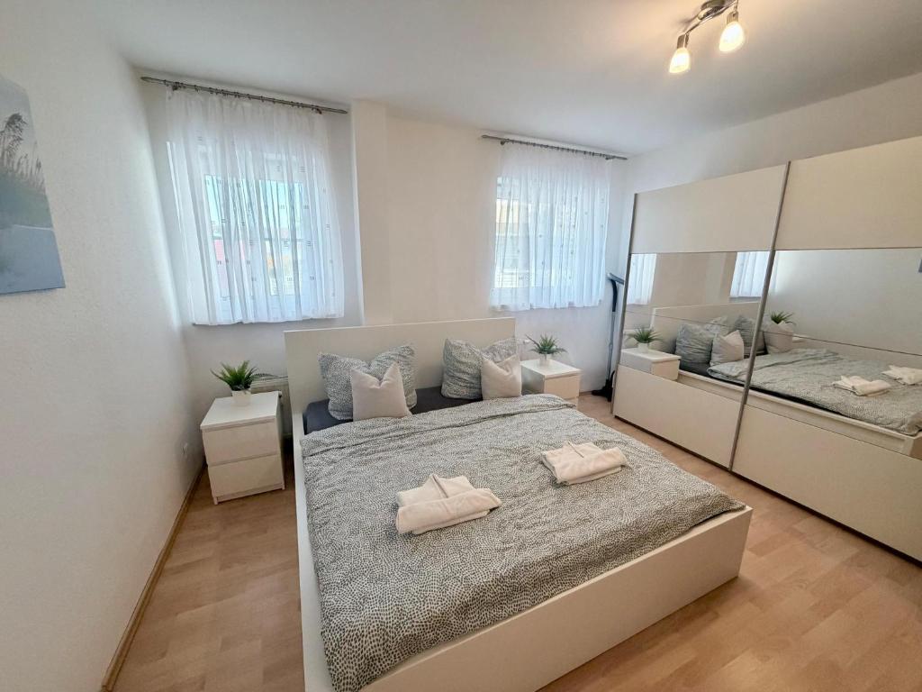 a bedroom with a large bed and a large mirror at Ferienwohnung DEICHBLICK 200m zum Strand Zingst Darß in Zingst
