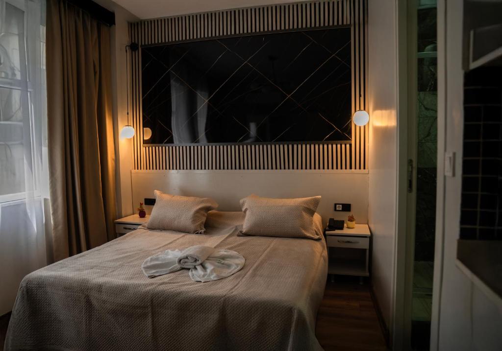a bedroom with a bed with a towel on it at Imperium Taxim in Istanbul