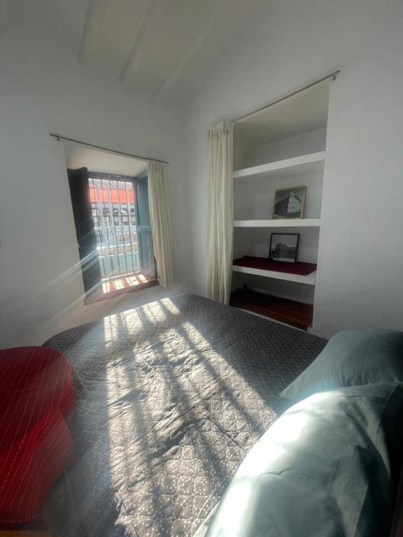 a bedroom with a large bed and a window at Casona Tres Reyes in Cusco