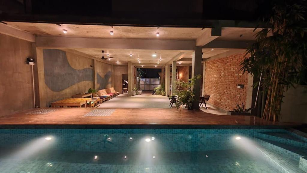 a swimming pool in the middle of a house at The Kheak in Weligama