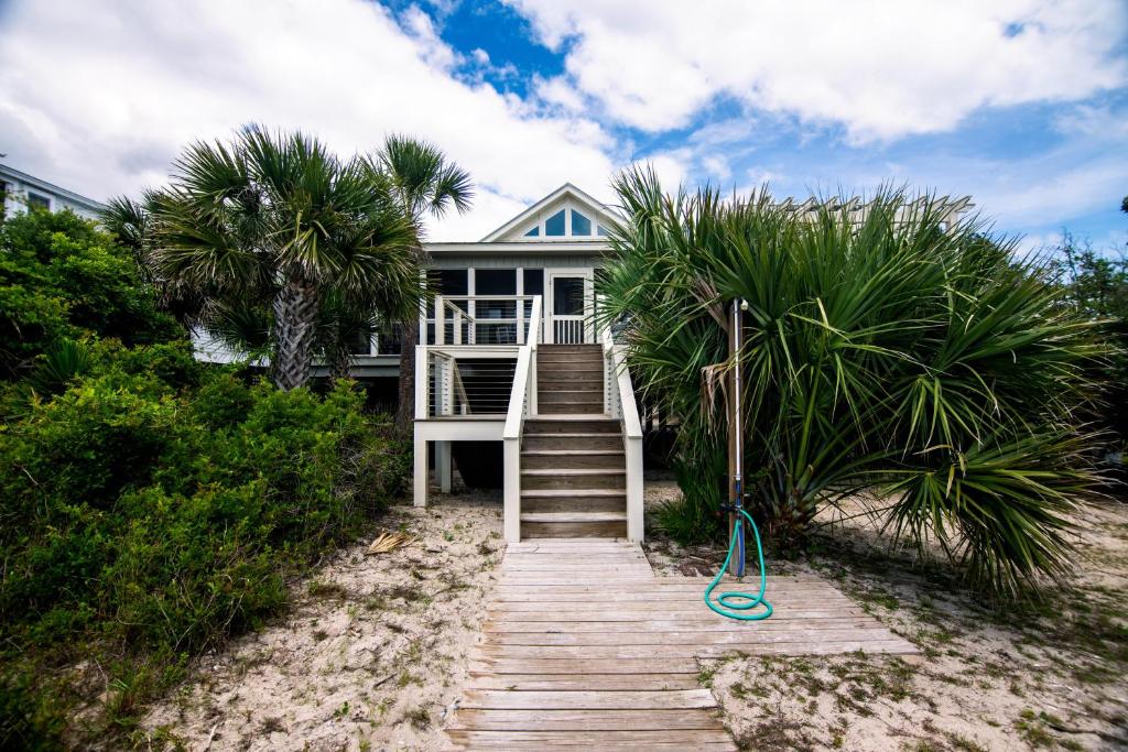a house on the beach with a wooden walkway at Crowfield in Edisto Beach