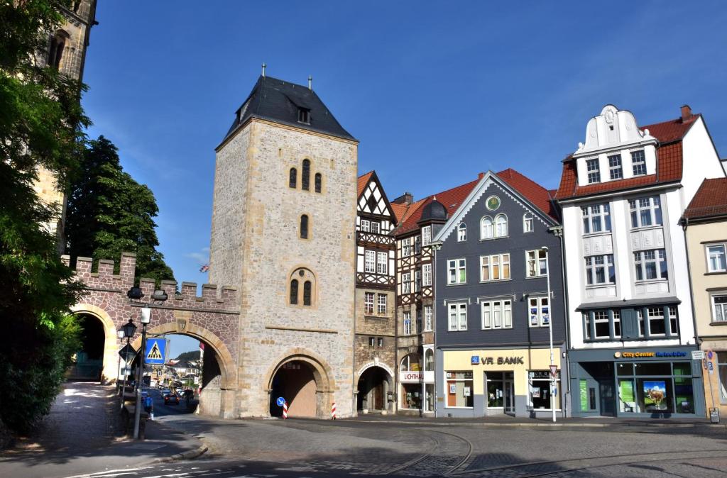 an old building with a clock tower on a street at Carl.22 City Appartements in Eisenach
