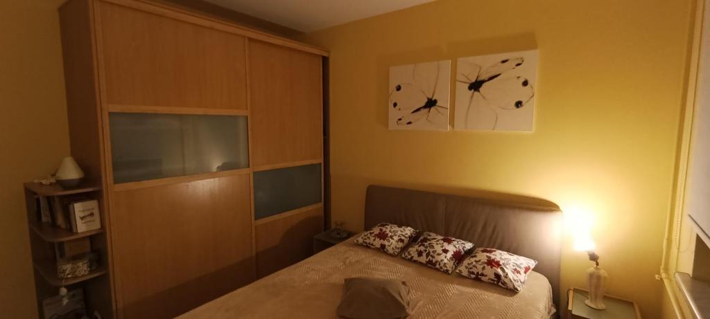 a bedroom with a bed and a clock on the wall at Ruola in Kaunas