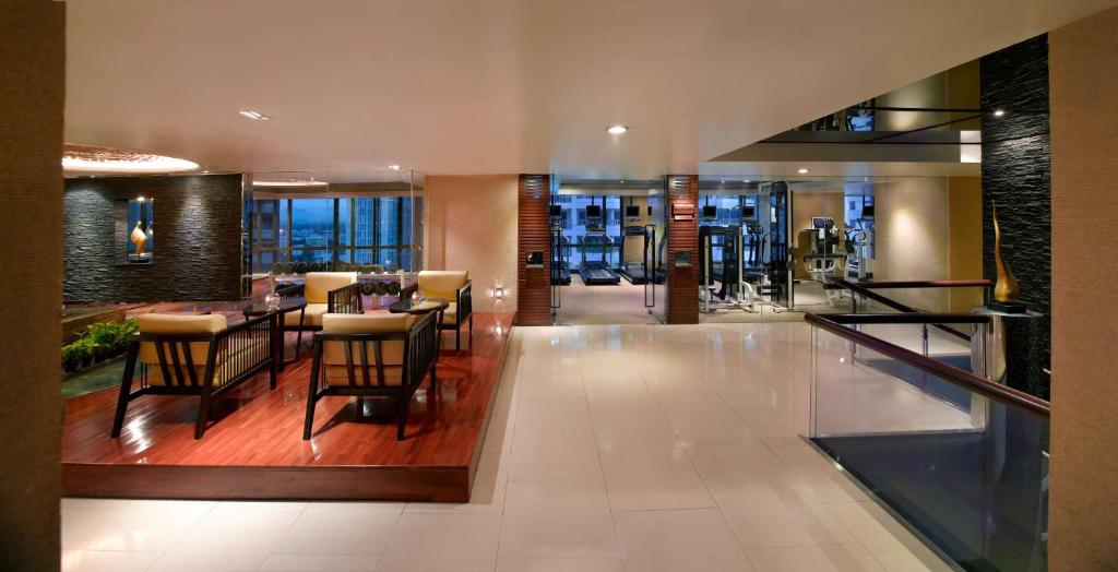An open hotel lobby with lounge seating, a bar area and a polished floor.