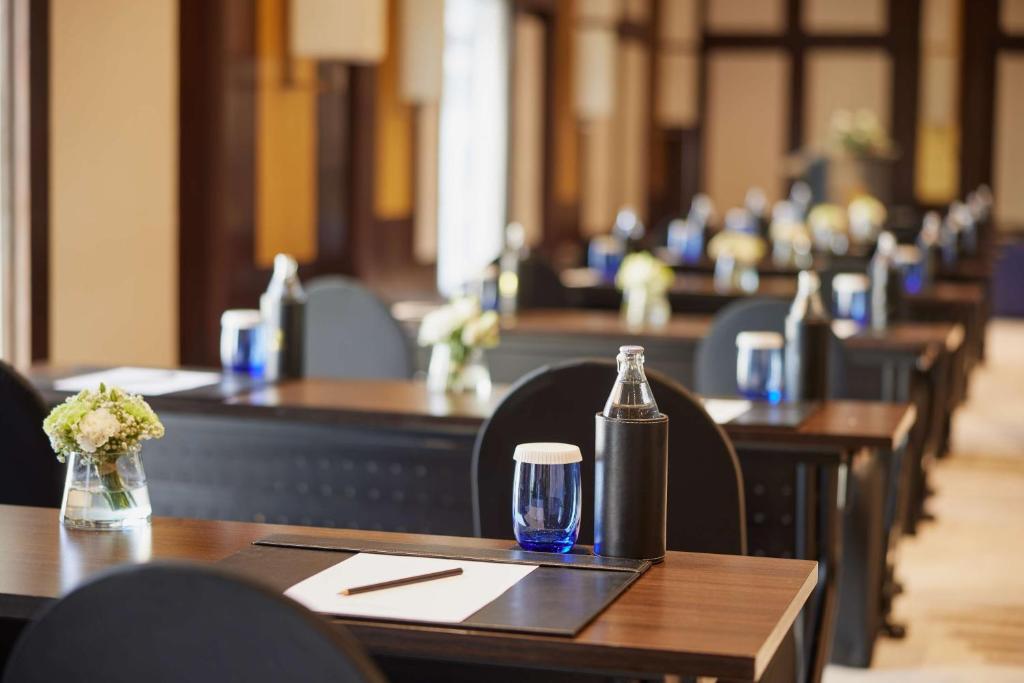 A bright dining room is set with rows of tables prepared for service.