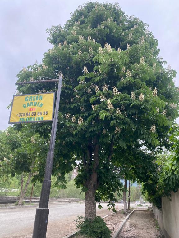 a tree on the side of a road with a sign at Church-View Lodge by Green Garden, Dilijan in Dilijan