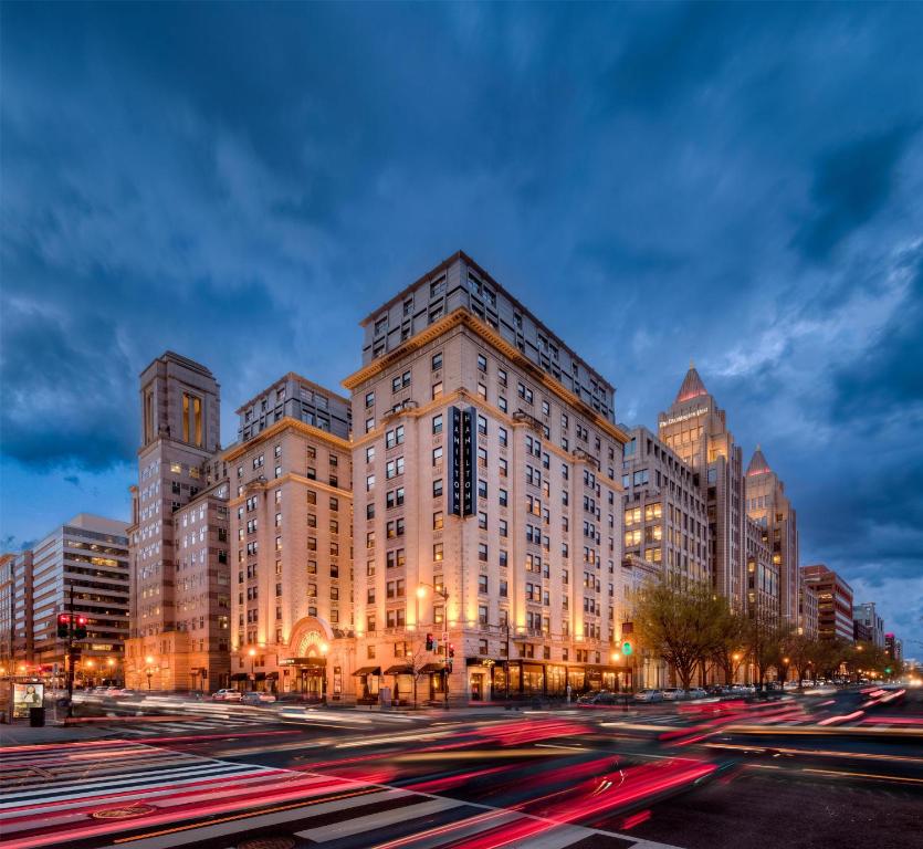a large building on a city street at night at Hamilton Hotel - Washington DC in Washington