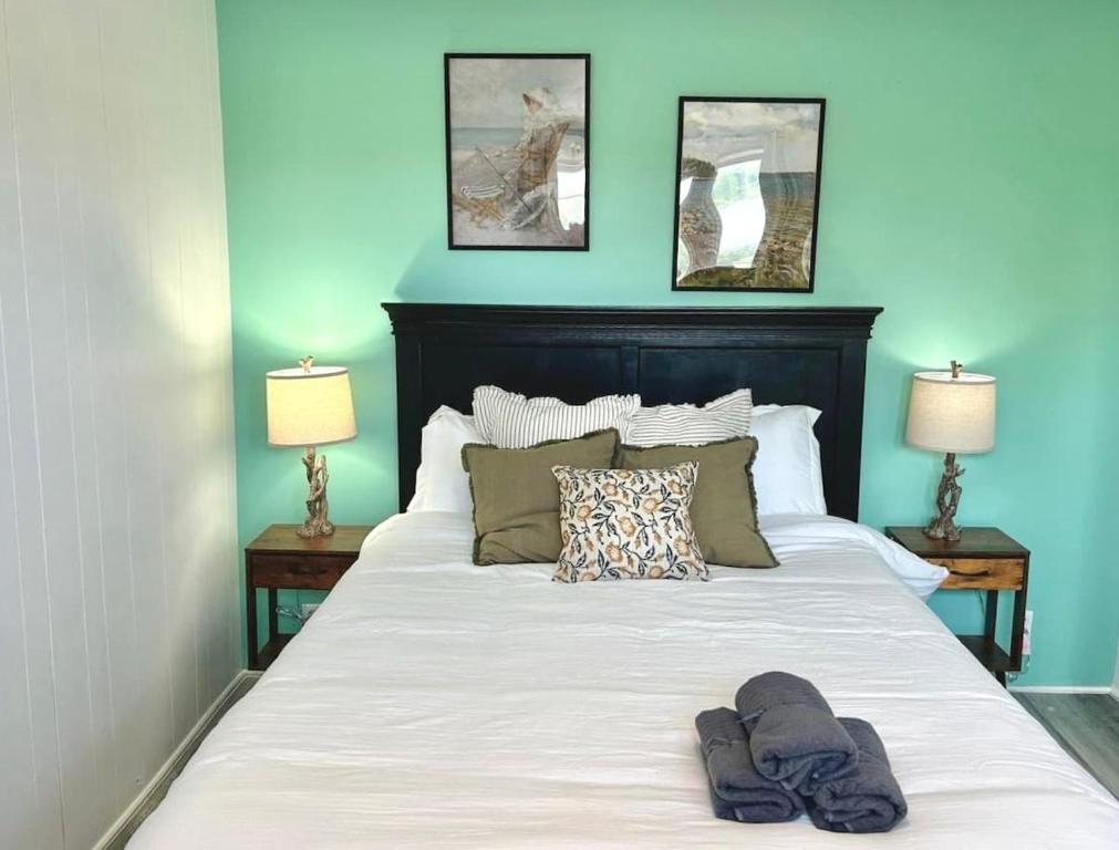 a bed with two pairs of slippers on top of it at 1-Bedroom Retreat Apt 3 in Bridgewater