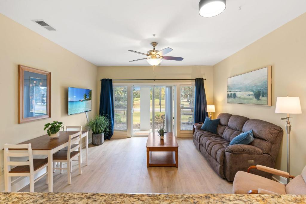 a living room with a couch and a table at World Tour 2BR Golf View Pool & Patio in Myrtle Beach