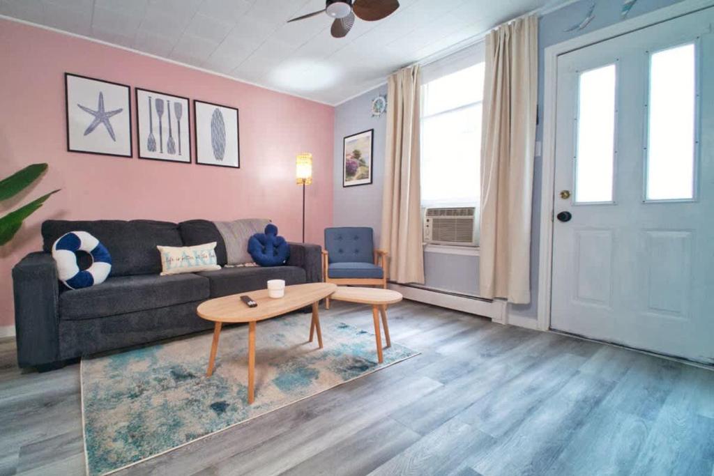 a living room with a couch and a table at 1BR Backyard Bliss - Apt 6 in Bridgewater