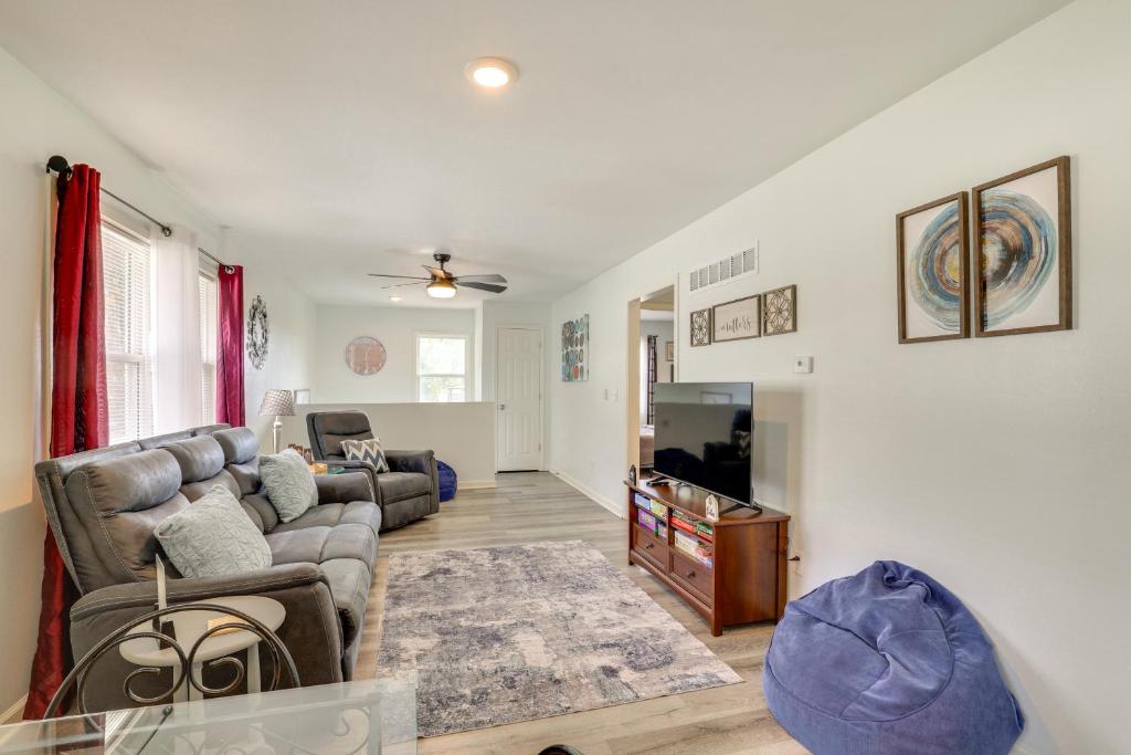 a living room with a couch and a tv at 'McBride Cul-De-Sac' Quiet Apt for Extended Stays in Sugar Creek