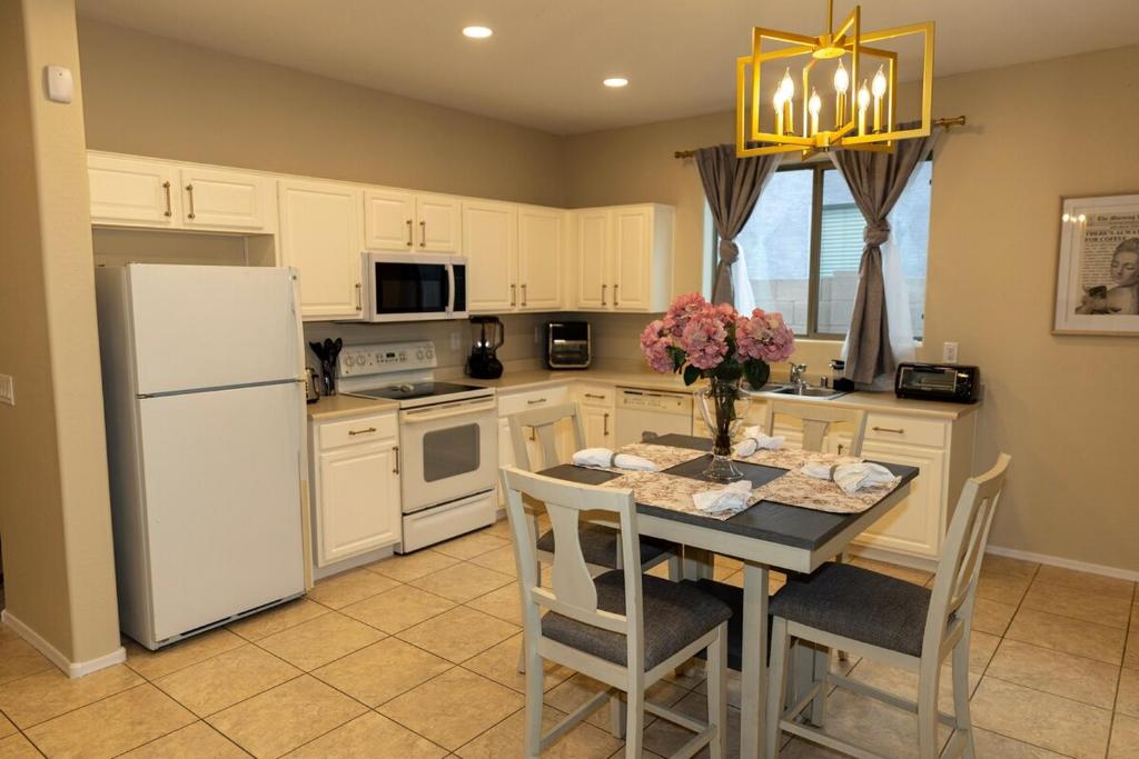 a kitchen with a table and a white refrigerator at The Margarita in Phoenix