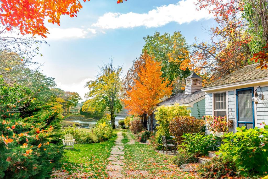a garden in the fall in front of a house at The Cottages at Cabot Cove in Kennebunkport