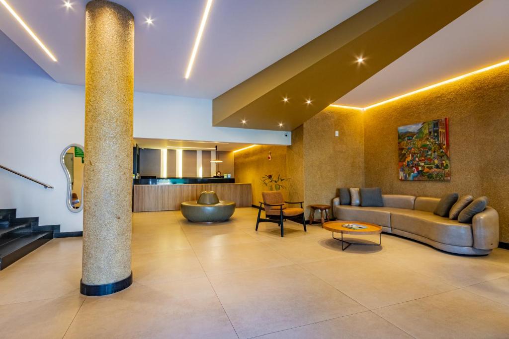 a living room with a couch and a table at Bevile Hotel in Cataguases