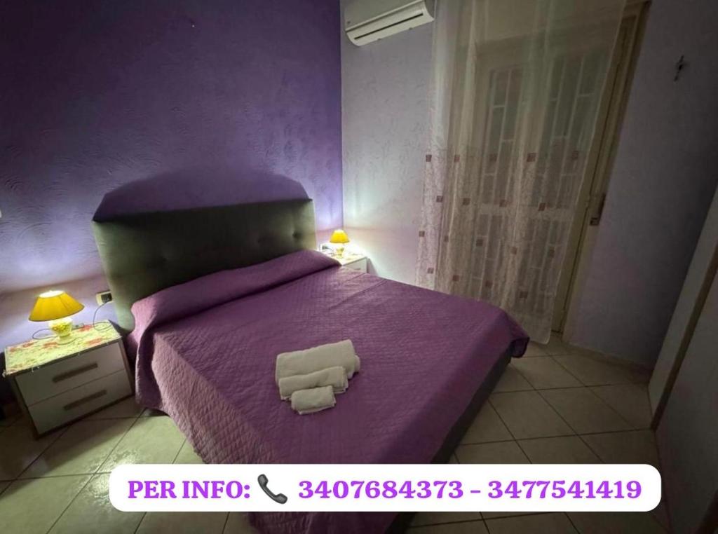 Postel nebo postele na pokoji v ubytování CasArcobaleno Fronte Policlinico