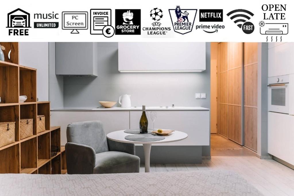 a kitchen with a table and a chair and a bottle of wine at E3 Luxury OldTown Apt - Free Parking, Supermarket, PCscreen, Netflix, Unlimited Music, Aircon in Košice