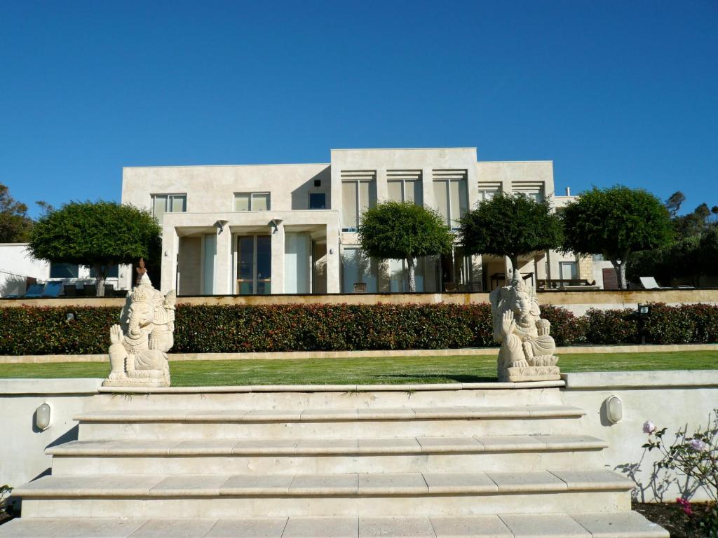 a large white building with statues in front of it at The Princess House in Prevelly
