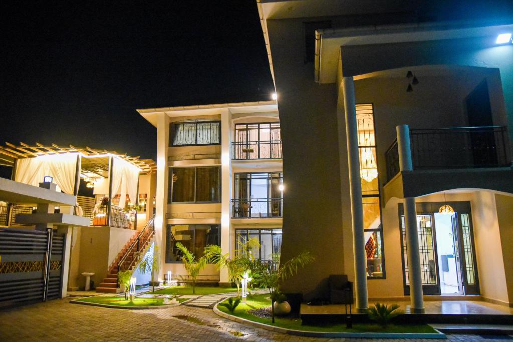 a large building at night with lights at Mileleishome in Buwate