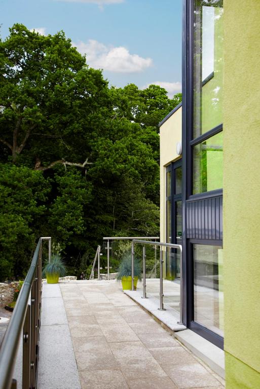 a walkway outside of a building with trees in the background at Clody Lodge in Bunclody