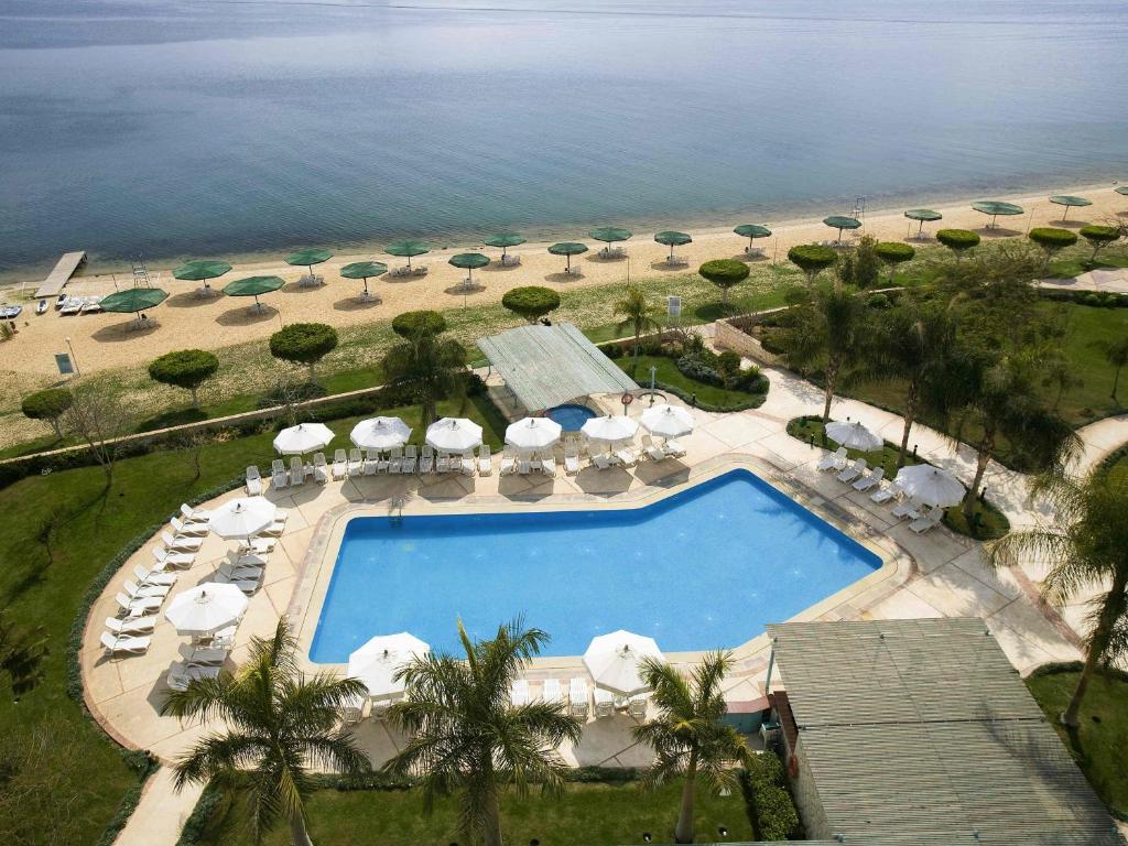 an aerial view of a resort pool and the beach at Mercure Ismailia Forsan Island in Ismailia